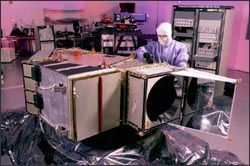 An engineer with the Landsat 7 ETM+ instrument in cleanroom.
