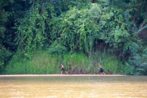 Children play near the Sesan River, which flows through central Vietnam and northeast Cambodia