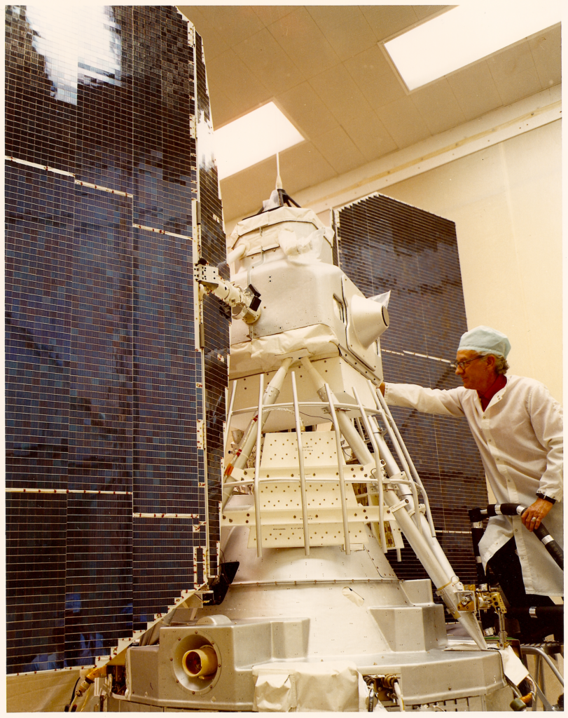 Landsat 2 in the cleanroom with a scientist examining it