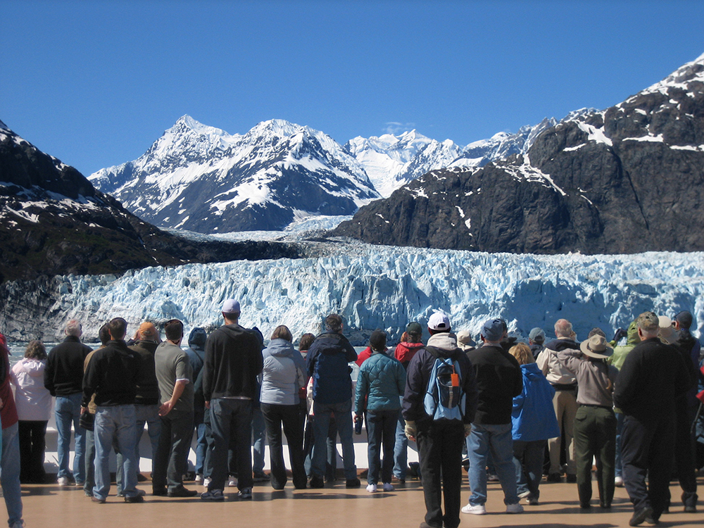 Visitors aboard a cruise ship admire a tidewater glacier in Glacier Bay National Park and Preserve