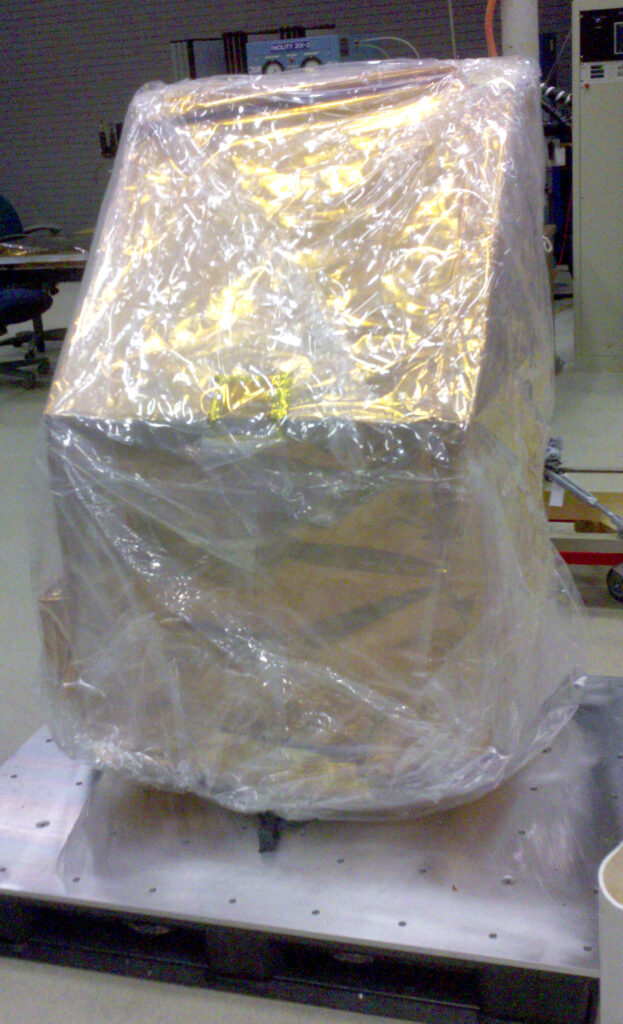 Mass model of TIRS wrapped in plastic.