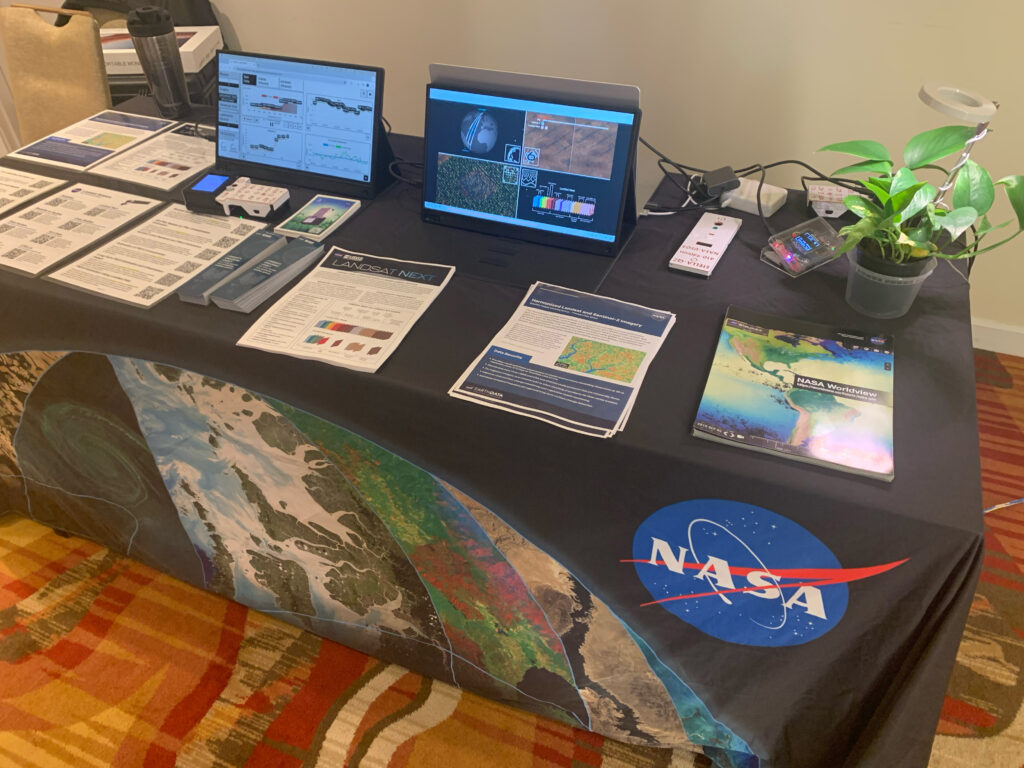 The Landsat table at LCLUC highlighted various outreach materials and displayed information about the Landsat Next mission, HLS, and the STELLA DIY handheld instruments.