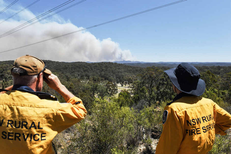 Members of Australia’s New South Wales Rural Fire Service monitor a fire in a remote region of the state that is also home to utility company transition lines. Credit: Indji Systems.