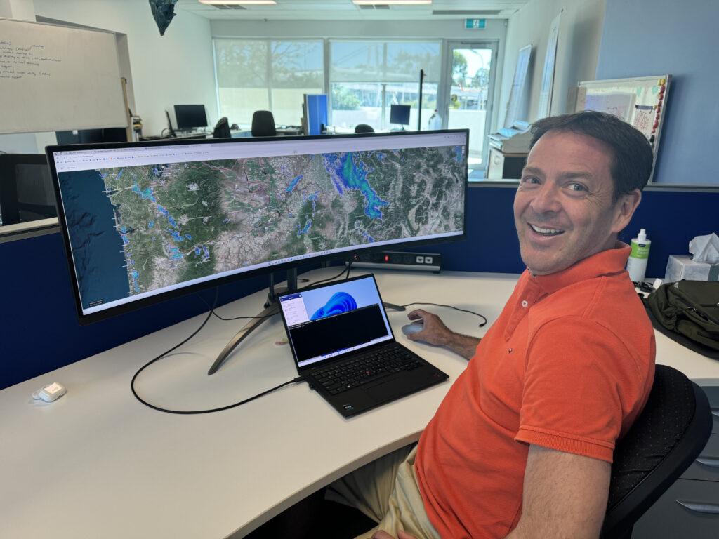 Mark Carniello, product manager for Indji Watch, monitors hazards on the Indji Watch system from his company's office in Perth, Australia. Credit: Indji Systems.
