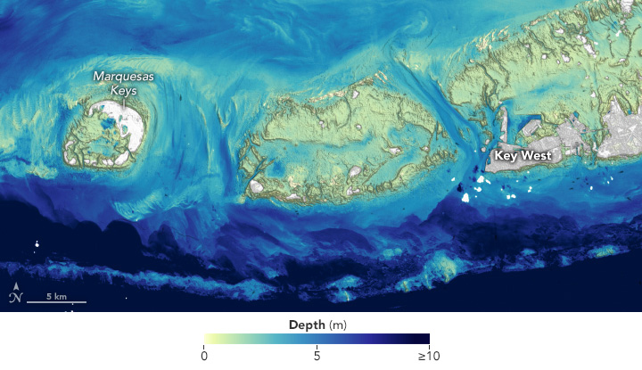 A Landsat-derived depth map that shows shallow channels cutting between low-lying islands, also called cays or keys. The shallow linear feature running across the bottom of the image is part of Florida’s stretch of coral reefs, which spans 350 miles (560 kilometers) from end to end.