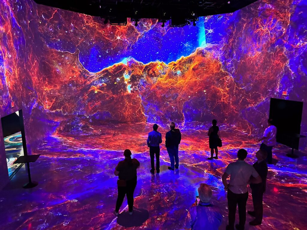 Guests enjoy Beyond the Light, a digital art experience featuring open NASA data, at ARTECHOUSE in Washington, D.C. on September 19, 2023. NASA/Wade Sisler